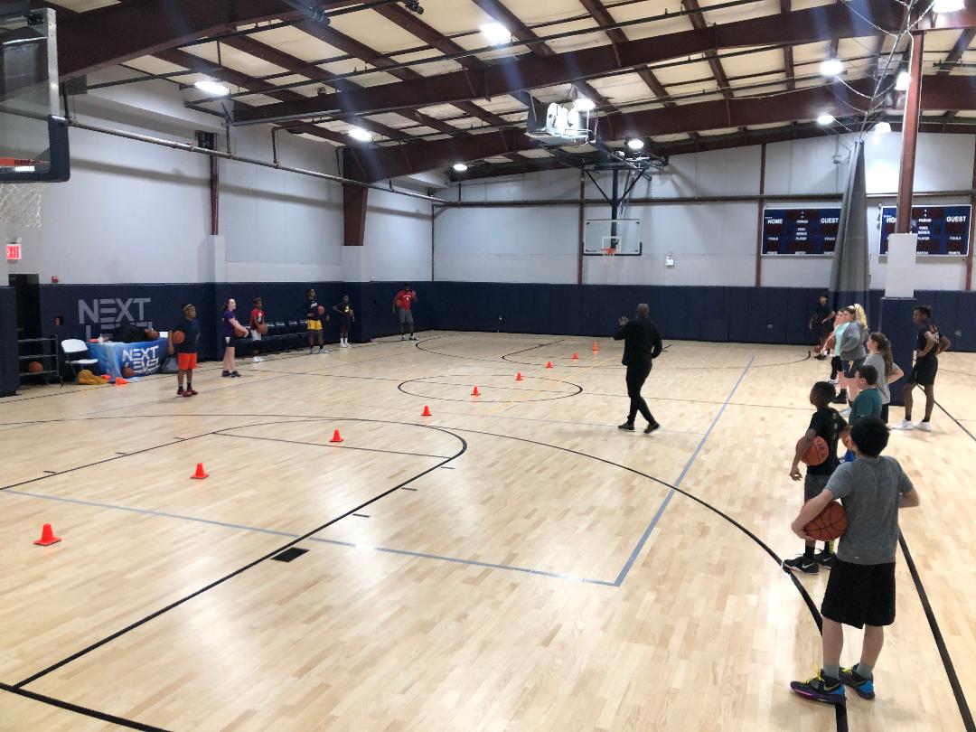 Basketball players practicing on a court.