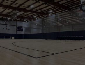 A basketball court with lights on the ceiling.